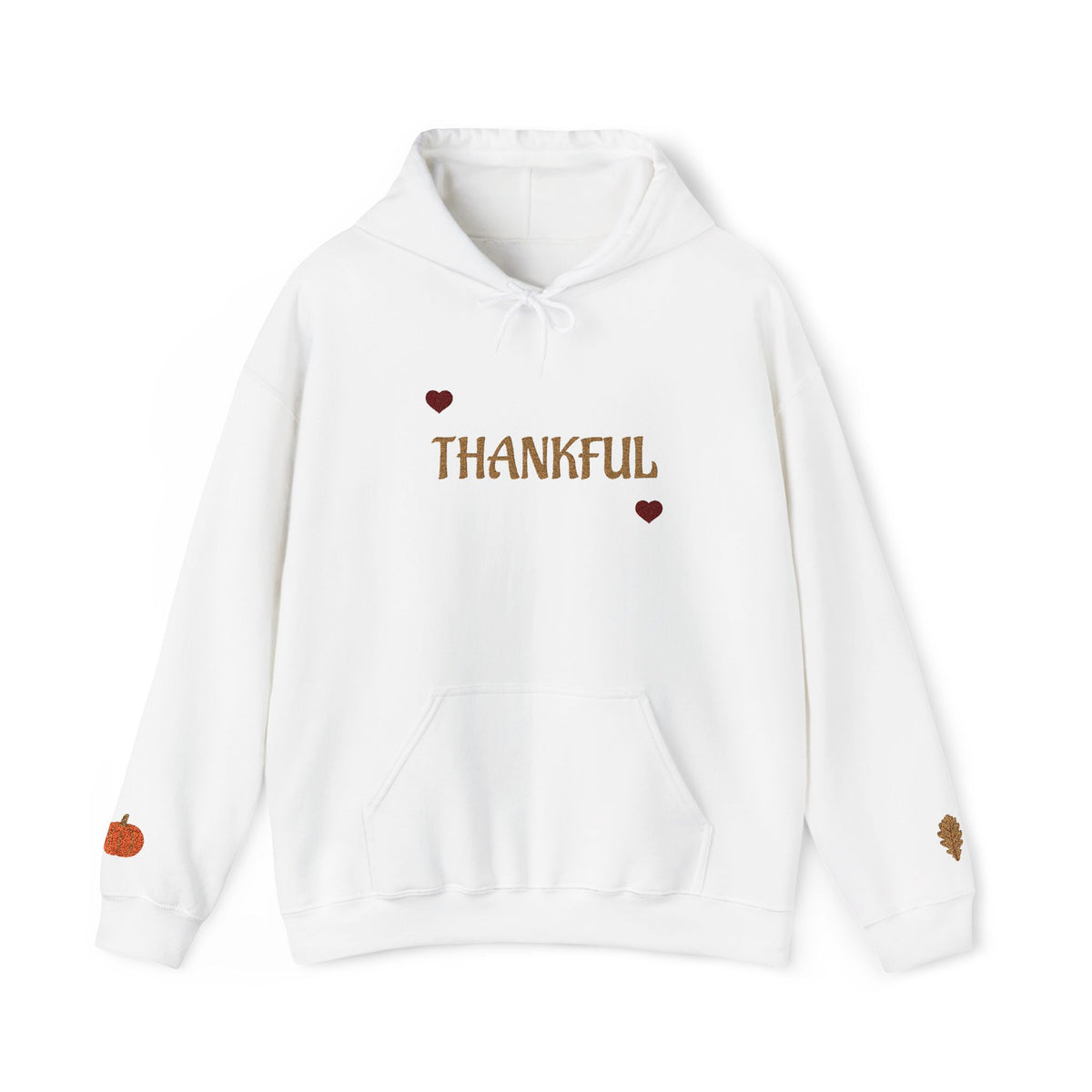 A white pullover hoodie with 'THANKFUL' printed in brown across the chest, flanked by two small brown hearts. The hoodie features a front kangaroo pocket, white drawstrings, a small orange pumpkin graphic on the left sleeve, and a small brown leaf graphic on the right sleeve.
