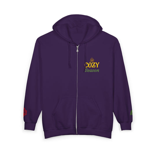 A dark purple zip-up hoodie with a drawstring hood, kangaroo pocket, and a 'COZY Season' graphic printed on the left chest. The hoodie is shown against a plain white background.