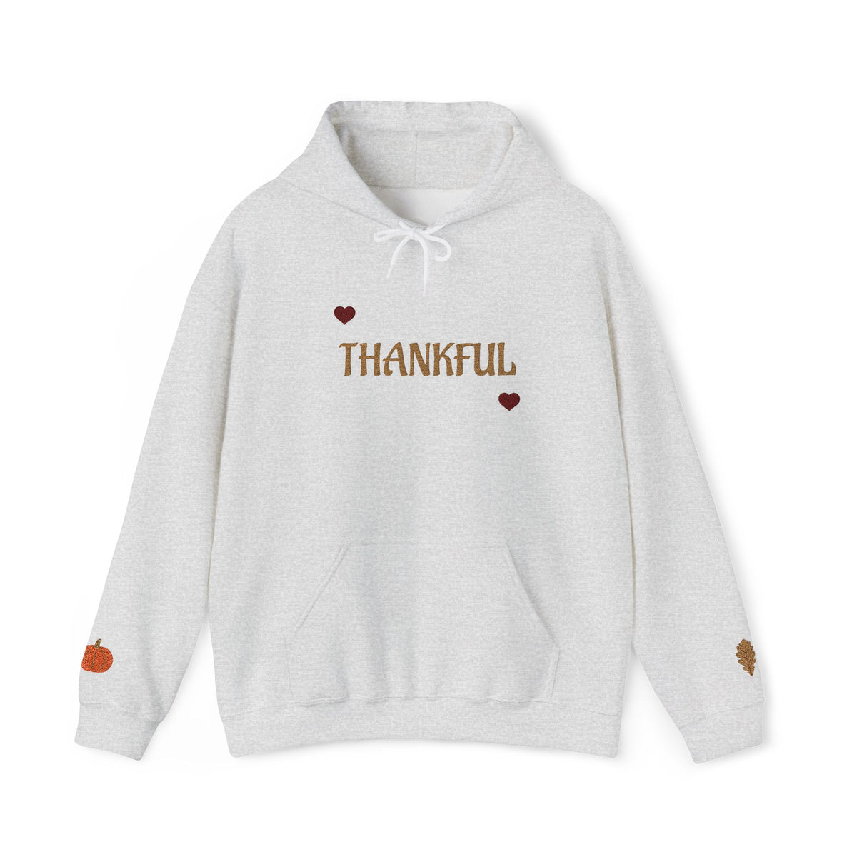 A light heather gray pullover hoodie with 'THANKFUL' printed in brown across the chest, flanked by two small brown hearts. The hoodie features a white drawstring hood, a front kangaroo pocket, a small orange pumpkin graphic on the left sleeve, and a small brown leaf graphic on the right sleeve, shown against a plain white background.