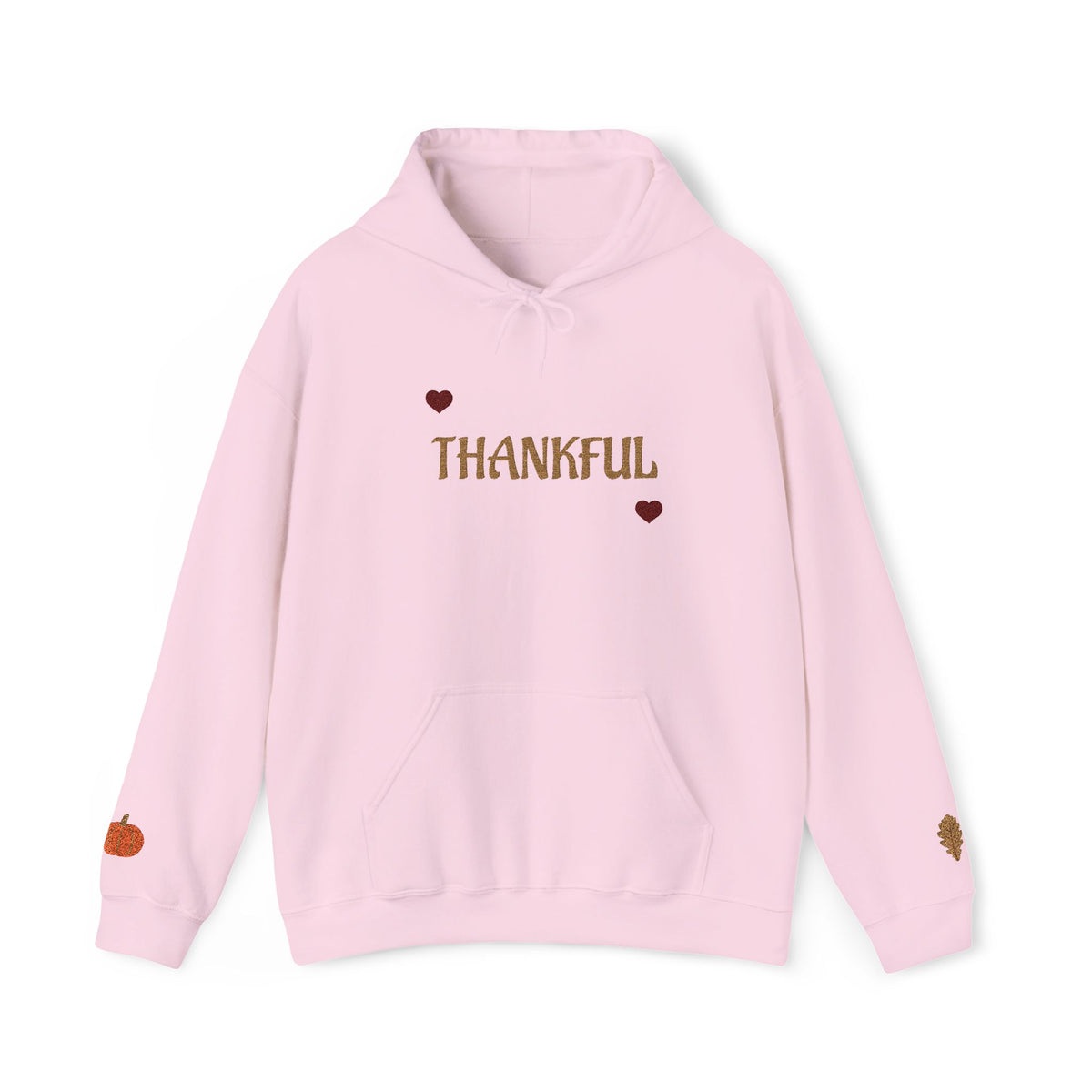 A light pink pullover hoodie with 'THANKFUL' printed in brown across the chest, flanked by two small brown hearts. The hoodie features a drawstring hood, a front kangaroo pocket, and small autumn-themed graphics on the cuffs, shown against a plain white background.